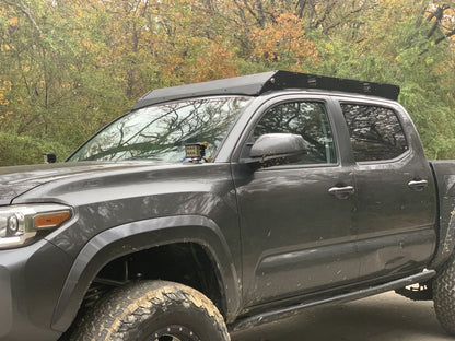 Front drivers side view of gray Toyota Tacoma with Premium roof rack - Cali Raised LED